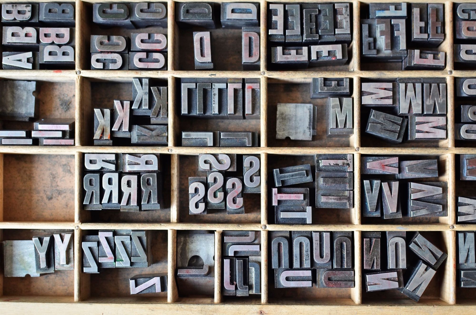 A compositor's type case filled with sorted metal letterpress type.
